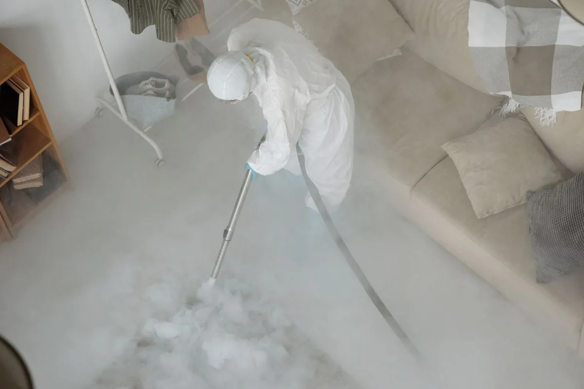 Biohazard cleanup technician in protective equipment, Pioneer Village, KY